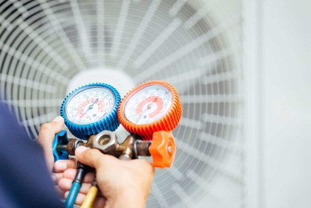 HVAC technician performing maintenance